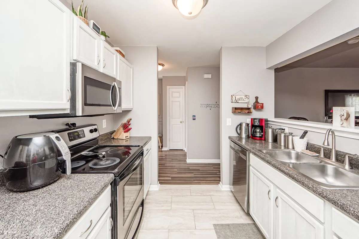 This image showcases a modern kitchen with sleek appliances, spacious countertops, and an inviting open layout. The scene is set up for cooking and socializing, with ample room for meal prep and group gatherings.